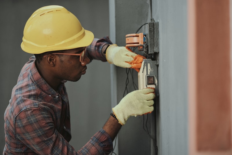 Hands installing a smart thermostat